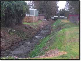 Image of drainage ditch after being cleared by the XL 330
