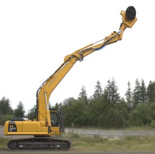 an HD 480B mounted on an excavator reaching up high and tilting toward the camera