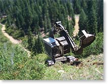 timbco self leveling cab with slashbuster brush cutter clearing brush on a steep slope